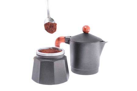 Pour coffee into a geyser coffee maker on a white background, a small depth of fieldの写真素材