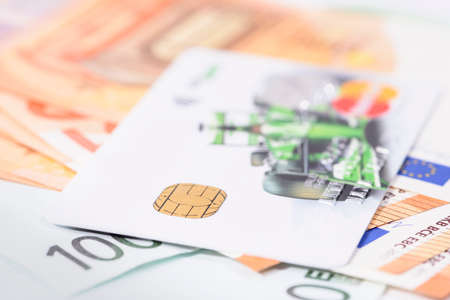 Bank card on a stack of cash close-up, shallow depth of fieldの写真素材