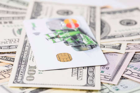 Bank card on a stack of cash close-up, shallow depth of fieldの写真素材