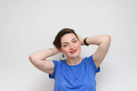 Portrait of a girl with a white sheet on a gray background