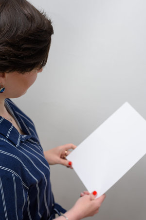 Portrait of a girl with a white sheet on a gray background