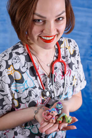 Photo of a pediatrician on a blue background with a stethoscopeの写真素材