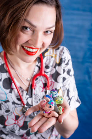 Photo of a pediatrician on a blue background with a stethoscopeの写真素材