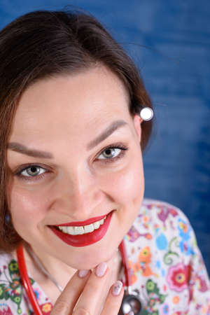 Photo of a pediatrician on a blue background with a stethoscopeの写真素材