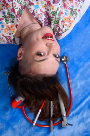 Photo of a pediatrician on a blue background with a stethoscopeの写真素材