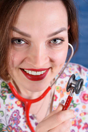 Photo of a pediatrician on a blue background with a stethoscopeの写真素材