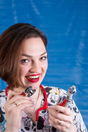 Photo of a pediatrician on a blue background with a stethoscopeの写真素材