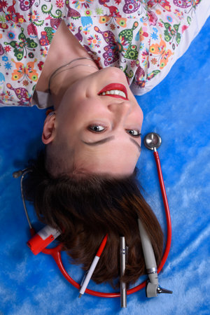Photo of a pediatrician on a blue background with a stethoscopeの写真素材