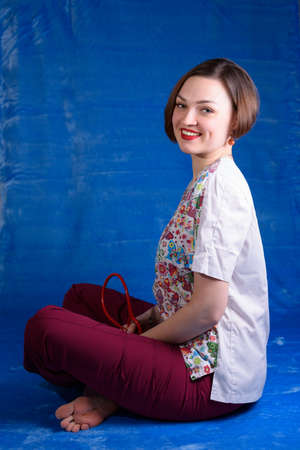 Photo of a pediatrician on a blue background with a stethoscopeの写真素材