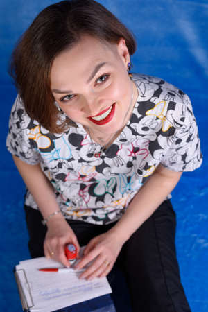 Photo of a pediatrician on a blue background with a stethoscopeの写真素材
