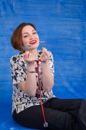 Photo of a pediatrician on a blue background with a stethoscopeの写真素材