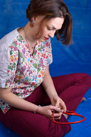 Photo of a pediatrician on a blue background with a stethoscopeの写真素材