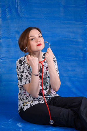 Photo of a pediatrician on a blue background with a stethoscopeの写真素材