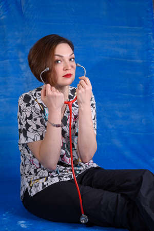 Photo of a pediatrician on a blue background with a stethoscopeの写真素材