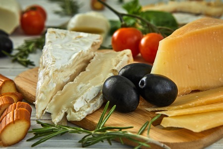 Different cheeses on table. Fresh dairy products. Cheese selection on a wood table, Gourmetの写真素材