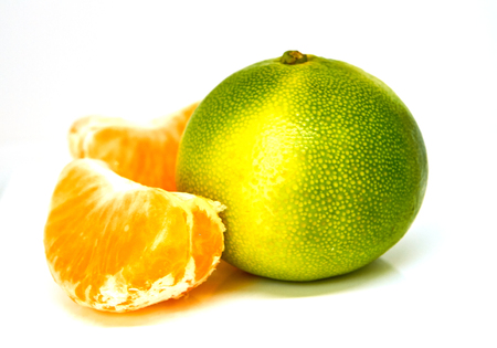 Green yellow mandarin isolated on white backgroundの写真素材