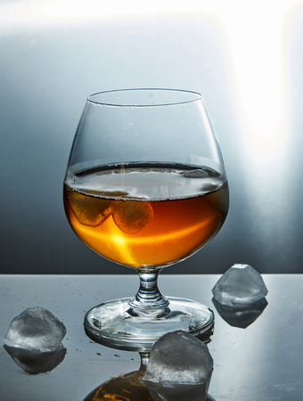 A glass of whiskey with ice. Conceptual designの写真素材
