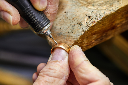 Jewelry production. The process of drilling holes in the ring. Jewelry making.の写真素材