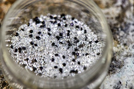 Brilliant white and black diamond in a special box for tackingの写真素材