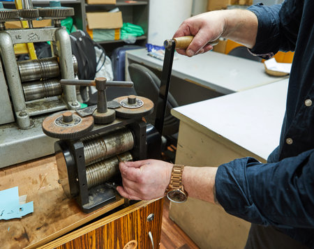 Jewelry production. Recycling raw materials. Jewelry craft on the metal-rolling machine. Metal tool...