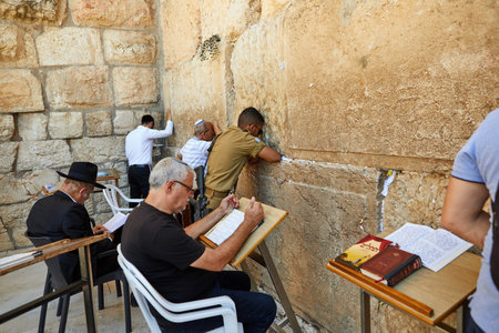 Jerusalem, Israel - July 10, 2019: View of unknowns people praying front the Western wall in the old city of Jerusalem. The Wailing Wall - Day of Jerusalem, Yom Kippur, Sukkotのeditorial素材