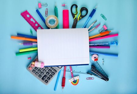 School office supplies on a blue background with copy space. Back to school concept.の写真素材