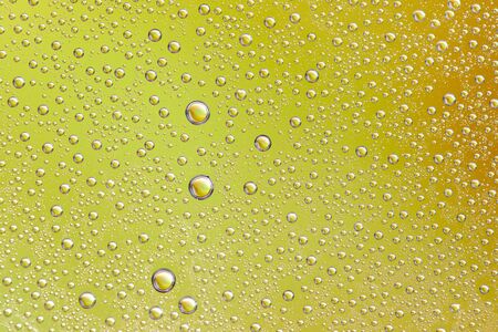 Drops on glass of different sizes and colors on a colored background, texture.の写真素材