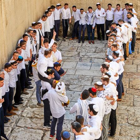 Jerusalem, Israel - October 21, 2019: A group of religious people celebrate Simchat Torah. Sing songs and hold Torah scrolls.のeditorial素材