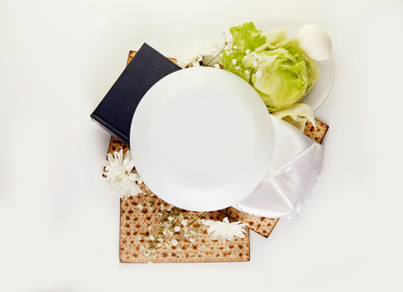 Pesah celebration concept - jewish Passover holiday Matzah background and seder plate, egg and...