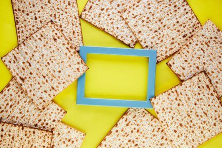 Pesah celebration concept - jewish Passover holiday. Matzo background on a yellow background with a...