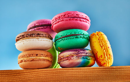 Multi-colored Macaron folded in a stack on a wooden background. Shooting from below.の写真素材
