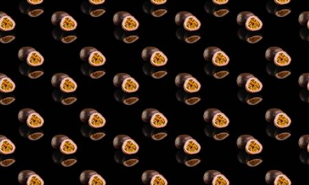 Passiflora half fruit and a whole pattern isolated on a black background.の写真素材