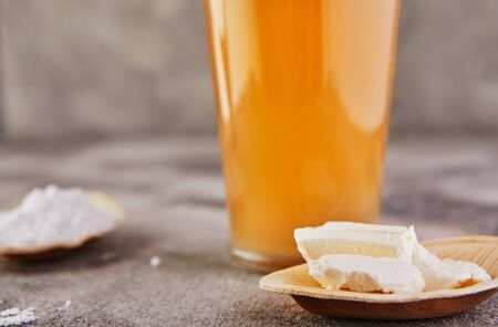 Fashionable food and drink glass of iced oolong tea with a layer of cream cheese foam with cocoa powder, a traditional Chinese drink on a gray background. Selective focus. Close-up. Copy space.の写真素材
