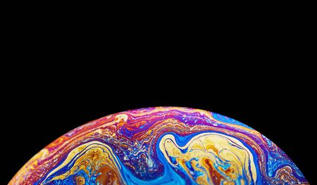 Virtual reality space with abstract multicolor psychedelic planet. Closeup Soap bubble like an alien planet on black background.の写真素材