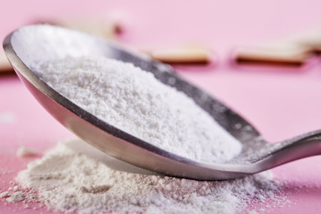 Collagen powder on a pink background. Extra protein intake. Natural cosmetic supplement for skin,...