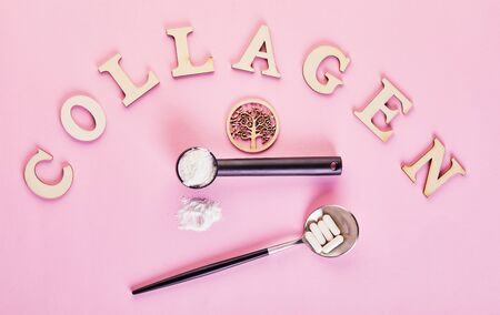 Collagen powder and pills on pink background. Extra protein intake. Natural beauty and health supplement for skin, bones, joints and gut. Plant or fish based. Top view. Copy space.の写真素材