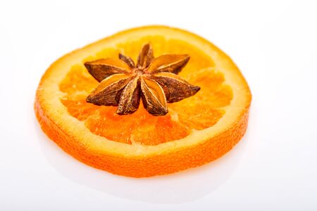 Slices of dried oranges or tangerines with anise isolated on a white background. Vegetarianism and healthy eating.の写真素材