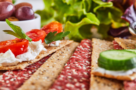 Beetroot and rye flour crackers with vegetables for making snacks on a wooden background. Vegetarianism and healthy eating.の写真素材