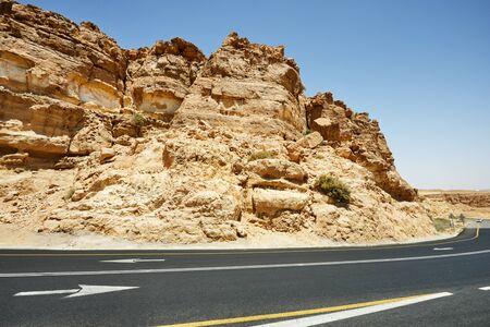 Landscape Mahtesh - Ramon Crater, in the Negev Desert, Southern Israel. This is the geological relief of a large erosive circus. The road through the crater towards Eilat.の写真素材