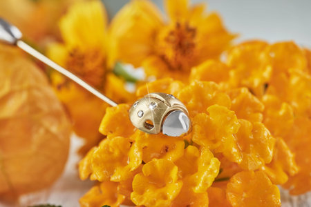 Brooch in white and yellow gold in the shape of a ladybug with diamonds on yellow-orange colors....