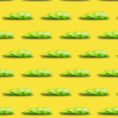 Edamame or soybeans pod pattern isolated on yellow background.