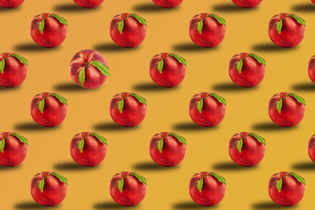 Fresh juicy peach with green leaves isolated on golden harvest background.