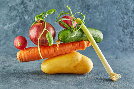A gourmet food composition with colorful vegetables on a purple background, for a fun gastronomy and...