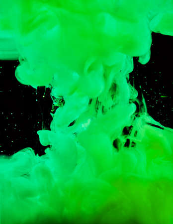 Colorful Abstract Painting Acrylic painting background texture in water creates an interesting abstraction against a black background. Spray of green colors.の写真素材