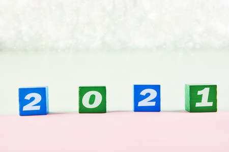 Concept for 2021. Wooden blocks with text and shiny background on the table.の写真素材