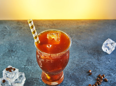 Cold drink or Nitro Coffee drink in a glass with bubble foam and ice, top view.