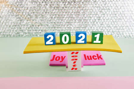 Concept for 2021. Wooden blocks with text and shiny background on the podium with wishes.の写真素材