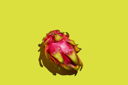 Dragon fruit - whole pitahaya on a yellow background.の写真素材
