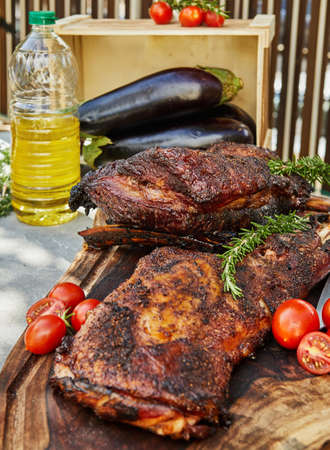 Slow-smoked lamb tenderloin on the grill with vegetables.の写真素材