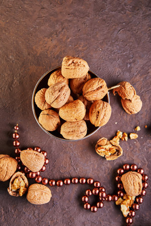 Walnuts in a tin cup, whole and finely chopped, next to the filling and shell. Home storage of...